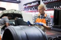 Mechanic man with laptop making car diagnostics at service Royalty Free Stock Photo