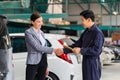 Mechanic man shaking hands with customer at the repair garage. Auto mechanic shaking hands with young woman client, Car repair and Royalty Free Stock Photo