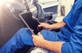 Mechanic man with tablet pc making car diagnostic Royalty Free Stock Photo