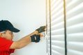 Mechanic man using electric drill machine on the wall Royalty Free Stock Photo