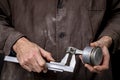 A mechanic measuring the piston of an internal combustion engine. Work in a mechanical workshop