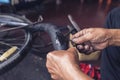 The mechanic patched the inner tube of the bicycle with glue and patch Royalty Free Stock Photo