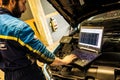 Mechanic perform chip tuning on tuned car in a garage workshop