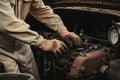 mechanic, performing maintenance on vintage car, with greasy hands and tools nearby Royalty Free Stock Photo