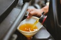 mechanic pouring oil to vehicle engine. serviceman changing motor oil in automobile repair service. maintenance & checkup in car