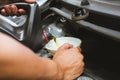 mechanic pouring oil to vehicle engine. serviceman changing motor oil in automobile repair service. maintenance & checkup in car Royalty Free Stock Photo