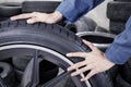 Mechanic pushing black tyre Royalty Free Stock Photo