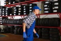 Mechanic ready to changing car tire using pneumatic wrench tool