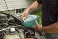 Mechanic Refilling Windshield Wiper Fluid In A Car Royalty Free Stock Photo