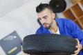 mechanic removes car tire close-up Royalty Free Stock Photo