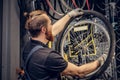 Mechanic repairing bicycle wheel tire in a workshop. Royalty Free Stock Photo