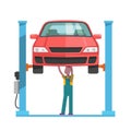 Mechanic repairing a car lifted on auto hoist Royalty Free Stock Photo