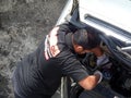 Mechanic repairing the faulty car at the workshop. Royalty Free Stock Photo
