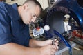 Mechanic Repairing Motorcycle At Garage