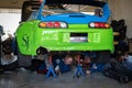 Mechanic repairing the transmission of a drifting toyota supra