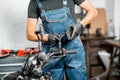 Mechanic repairing or tuning motorcycle