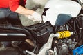 Mechanic repairman doing maintenance or repairing fixing on the motorcycle motorbike service center