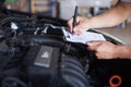 Mechanic repairman inspecting car