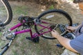 Mechanic repairman installing assembling or adjusting bicycle gear on wheel Royalty Free Stock Photo