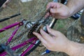 Mechanic repairman installing assembling or adjusting bicycle gear on wheel Royalty Free Stock Photo