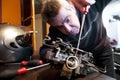 Mechanic repairs a carburetor Royalty Free Stock Photo