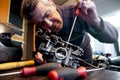 Mechanic repairs a carburetor Royalty Free Stock Photo