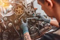 Mechanic repairs the engine of the car in a car-care center Royalty Free Stock Photo