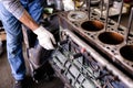 Mechanic repairs old motor of truck in a car repair station. Disassemble engine block vehicle. Motor capital repair. Car service Royalty Free Stock Photo