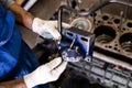 Mechanic repairs old motor of truck in a car repair station. Disassemble engine block vehicle. Motor capital repair. Car service Royalty Free Stock Photo
