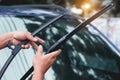 Mechanic replace windshield wipers on car. Replacing wiper blades Royalty Free Stock Photo