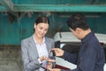 Mechanic returns the key to the satisfied custumer, Auto mechanic repairman handing car remote key to client, Car repair and