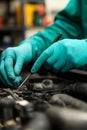 Mechanic s Gloved Hands Intently at Work, Performing Car Engine Maintenance and Repair Royalty Free Stock Photo