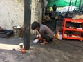 A mechanic is shaping his tools in dirty garage Bangkok Thailand April 2, 2018