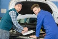 mechanic showing apprentice in doing diagnostic Royalty Free Stock Photo