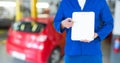 Mechanic showing a clipboard in garage