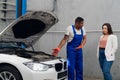 A mechanic shows the client the engine of a car Royalty Free Stock Photo