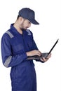 Mechanic standing with laptop