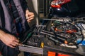 Mechanic taking facilities from special box for mechanical instruments Royalty Free Stock Photo