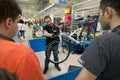 Mechanic teaching people how to adjust the brakes on a bicycle Royalty Free Stock Photo