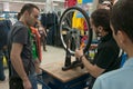 Mechanic teaching people how to true a bike wheel on a truing stand Royalty Free Stock Photo