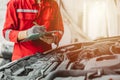 mechanic team check list engine repair maintenance oil liquid change at front hood of old car in auto service workshop Royalty Free Stock Photo