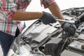 Mechanic, technician man check the car engine in garage. Car service, repair, fixing, checking maintenance working with socket Royalty Free Stock Photo