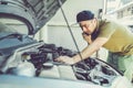 Mechanic, technician man holding clipboard and check the car eng Royalty Free Stock Photo