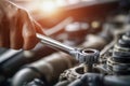 Mechanic tightening a bolt on an engine in a workshop Royalty Free Stock Photo