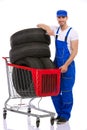 Mechanic with tires in shopping cart Royalty Free Stock Photo