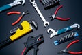 Mechanic tools on black background. Set of pipe wrench, bent wrench, nuts, spanner, pliers, and chrome combination wrenches. Royalty Free Stock Photo