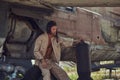 Mechanic in uniform and flight helmet carries out maintenance of an old military bomber in an open-air museum. Royalty Free Stock Photo