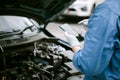 Mechanic use smartphone repair car. Royalty Free Stock Photo