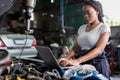 Mechanic using compute for Diagnostic  machine tools ready to be used with car. Car mechanic using a computer laptop to diagnosing Royalty Free Stock Photo