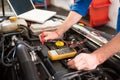 Mechanic using diagnostic tool on engine